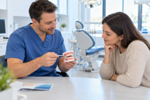 Dentist explaining care to a patient with a dental model